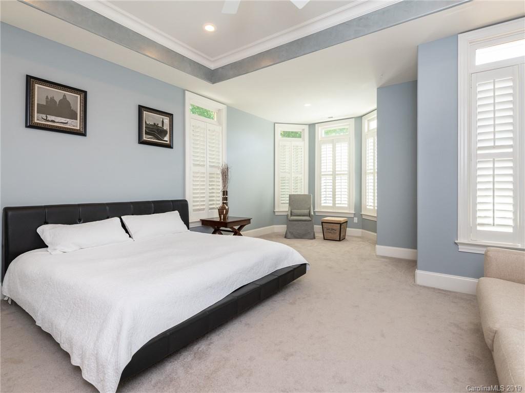18424 Nantz Road Cornelius, NC 28031 - Photo 40 of 47 a spacious bedroom with a large bed and a window