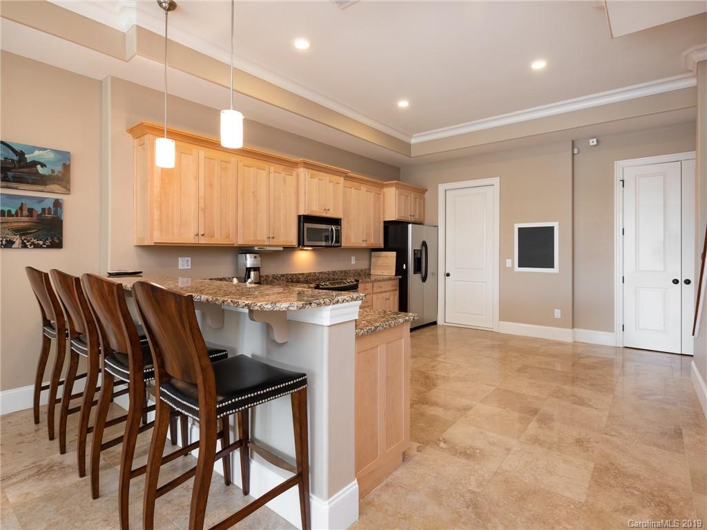 18424 Nantz Road Cornelius, NC 28031 - Photo 41 of 47 a kitchen with stainless steel appliances granite countertop a stove top oven a sink dishwasher and a refrigerator with wooden cabinets