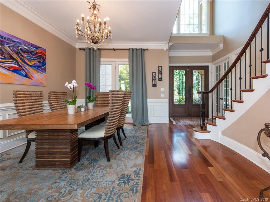 18424 Nantz Road Cornelius, NC 28031 - Photo 10 of 47 a dining room with furniture wooden floor and chandelier