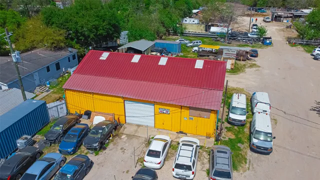 an aerial view of a house with garden space and street view