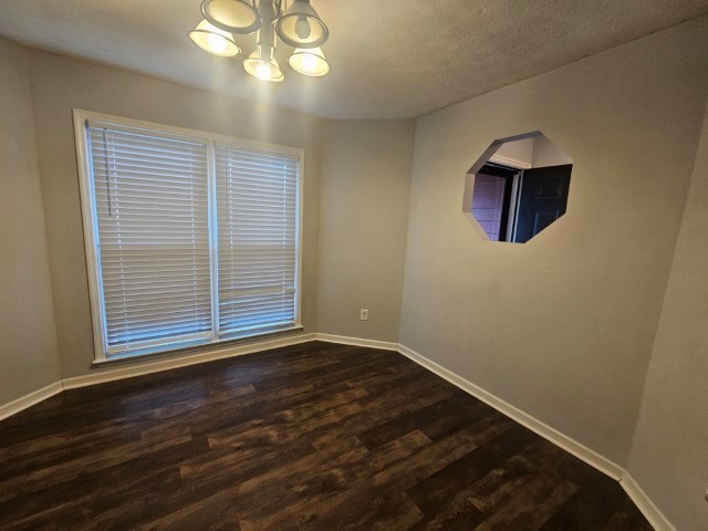 1804 Dallas Court Columbus, GA 31907 - Photo 13 of 50 a view of an empty room with wooden floor and a window
