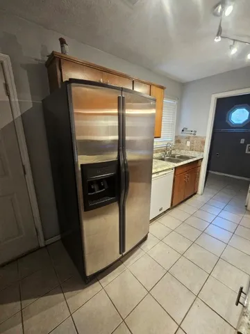 a kitchen with stainless steel appliances granite countertop a refrigerator and a stove