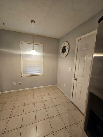 a view of an empty room and a window