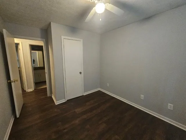 an empty room with wooden floor and entrance