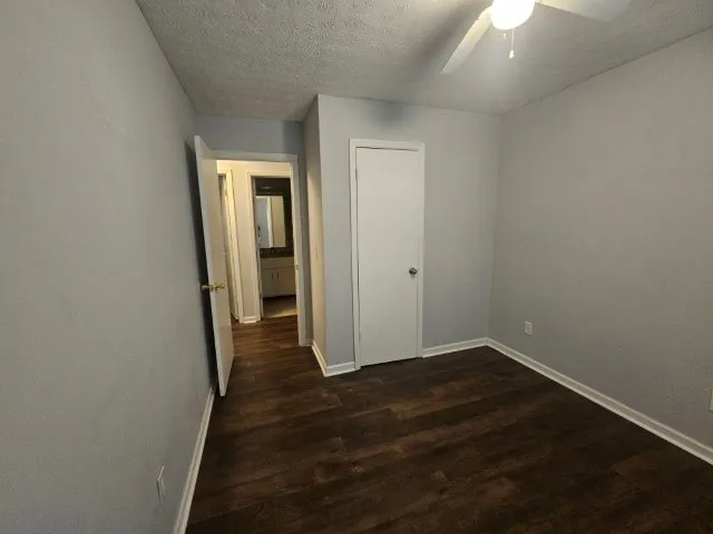 an empty room with wooden floor and closet