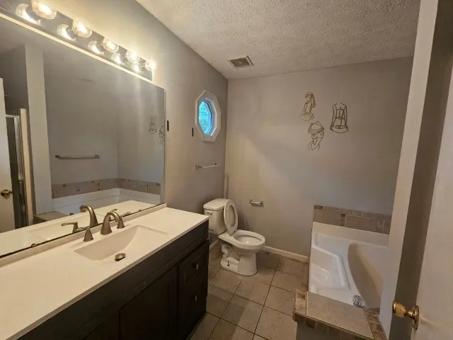 a bathroom with a sink mirror vanity and toilet