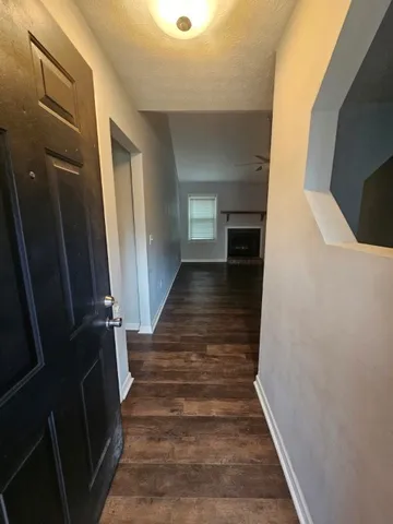 a view of entryway and hall with wooden floor