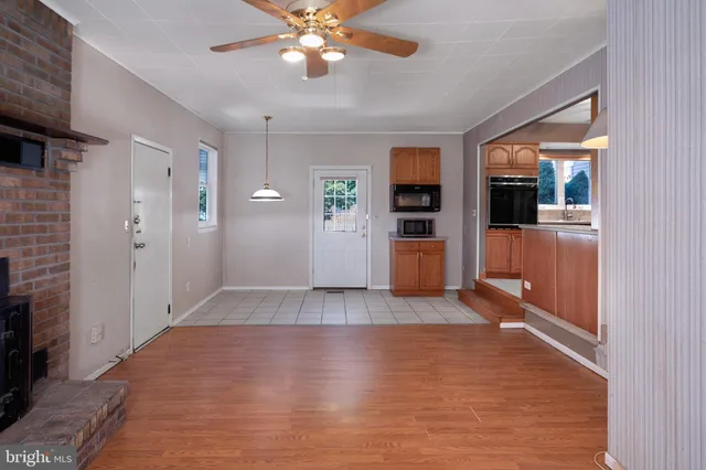 wooden floor in an empty room with a kitchen