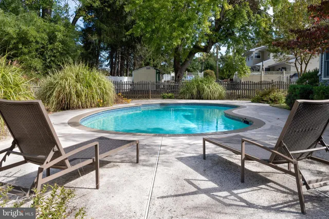 a swimming pool with outdoor seating and yard