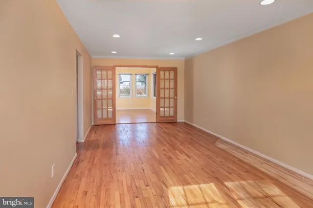 a view of empty room with wooden floor