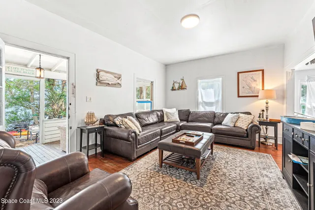 a living room with furniture a rug and a fireplace