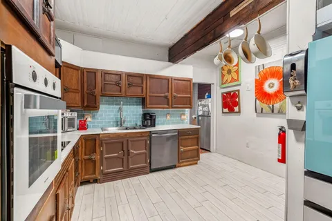a kitchen with stainless steel appliances granite countertop a sink and cabinets