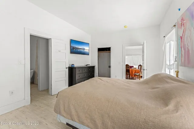 a bedroom with a bed and a dresser