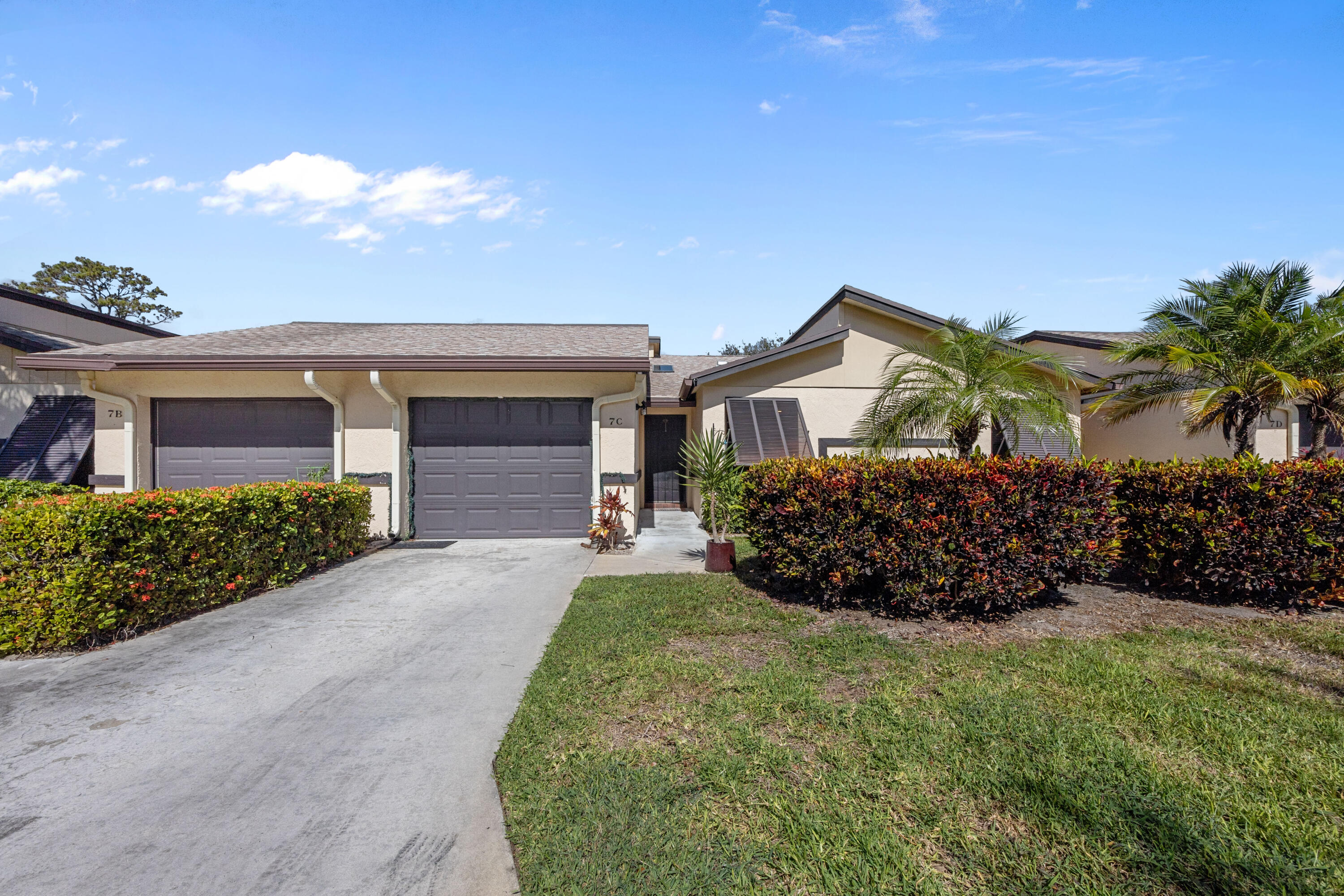 7 Ridge Pointe Drive, Unit C Boynton Beach, FL 33435 - Photo 1 of 29 a front view of a house with a garden and yard
