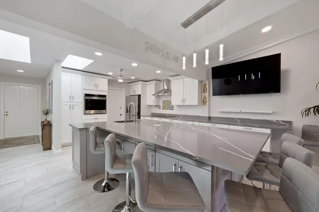 a kitchen with a table chairs refrigerator and microwave