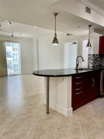 a kitchen with stainless steel appliances granite countertop a stove a refrigerator and a sink