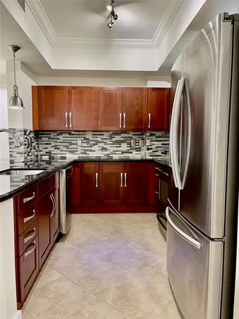 a kitchen with stainless steel appliances granite countertop a stove sink and cabinets