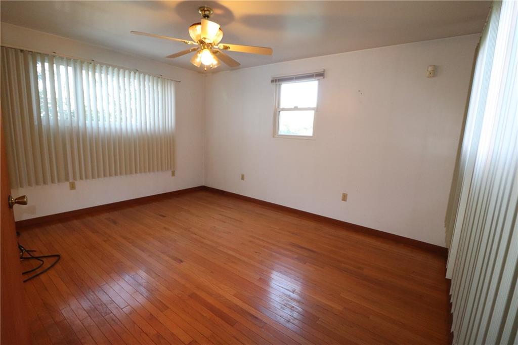 3397 Ridgway Street Pittsburgh, PA 15213 - Photo 18 of 33 an empty room with wooden floor chandelier fan and windows