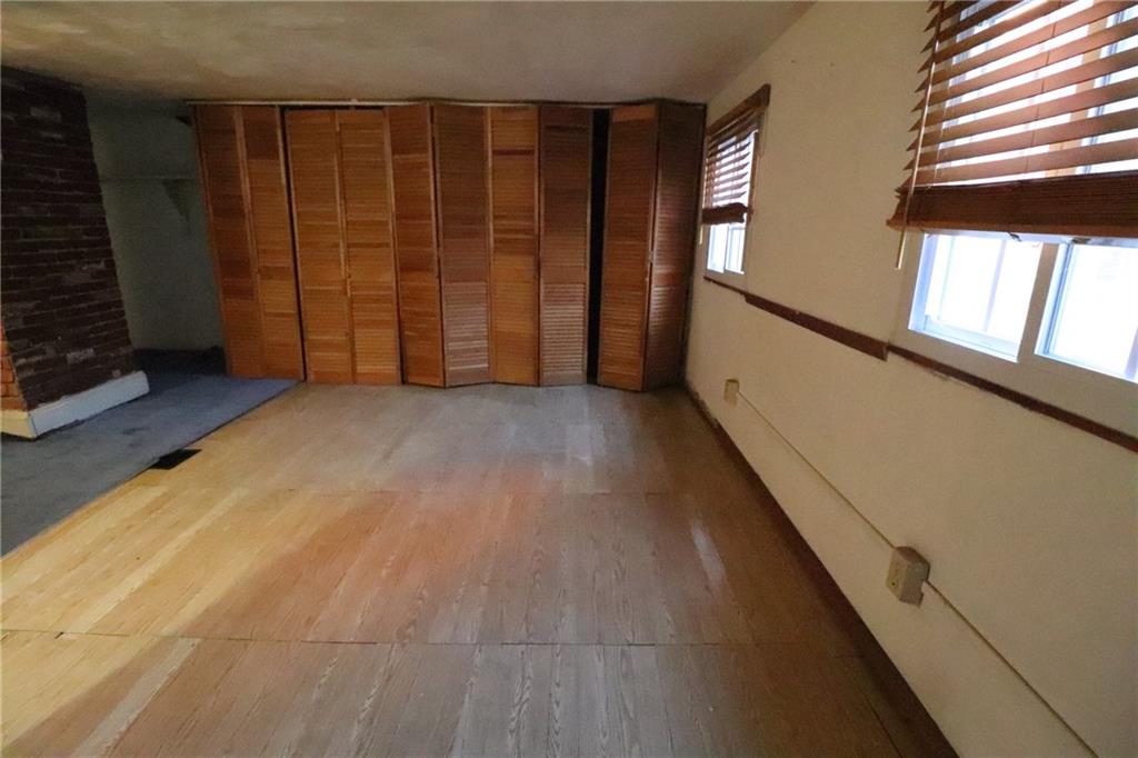 3397 Ridgway Street Pittsburgh, PA 15213 - Photo 24 of 33 a view of an empty room with wooden floor and a window