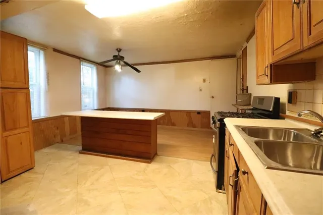 a kitchen with a sink and a stove top oven
