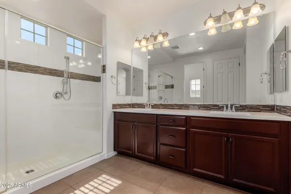 a bathroom with a double vanity sink and a mirror