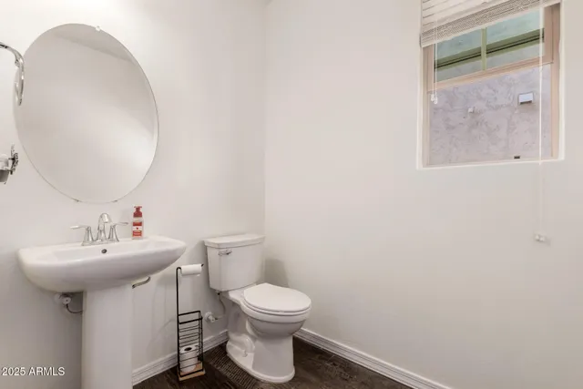 a bathroom with a sink mirror and toilet