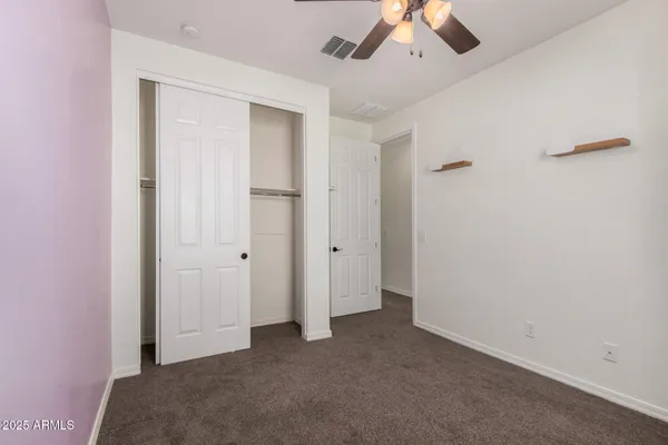 a view of a livingroom with a ceiling fan and window
