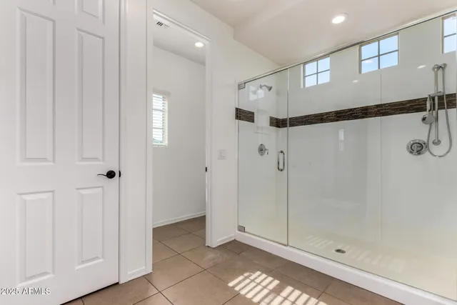 a bathroom with a glass shower door