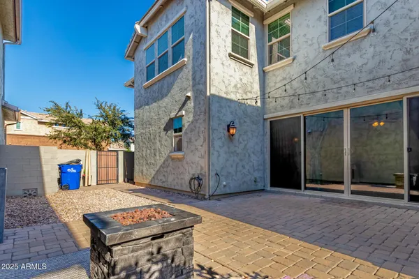 a backyard of a house with barbeque oven table and chairs