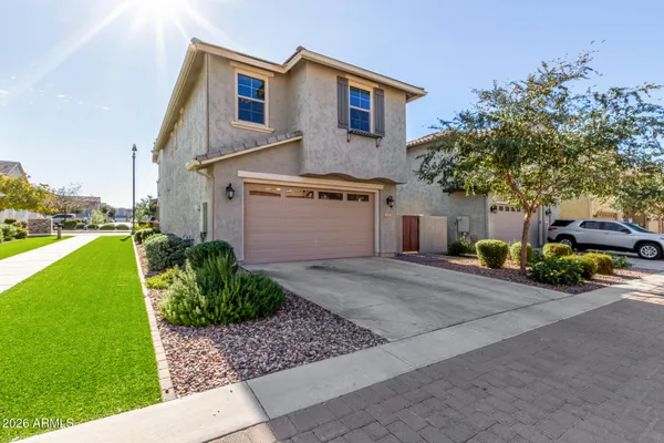a front view of a house with a yard and garage