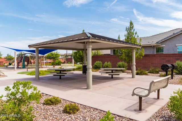 a view of a patio with a table and chairs under an umbrella