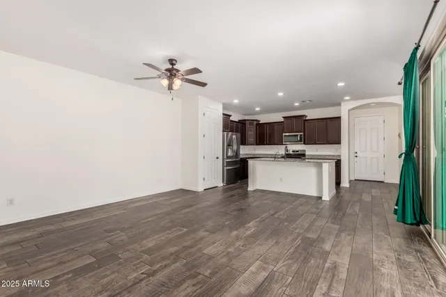 a view of kitchen with stove microwave and refrigerator