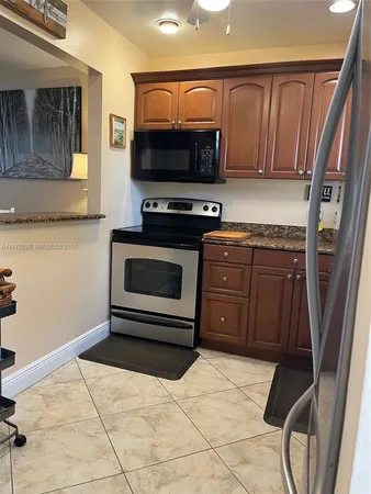 a kitchen with a stove a microwave and sink