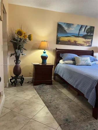 a bedroom with a bed and a potted plant