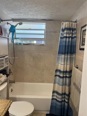 a bathroom with a toilet and a bathtub