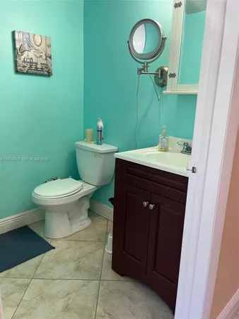 a bathroom with a toilet sink and mirror