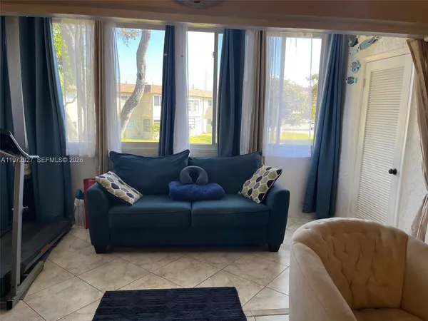 a living room with furniture and a window