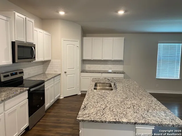 a kitchen with a stove and a microwave
