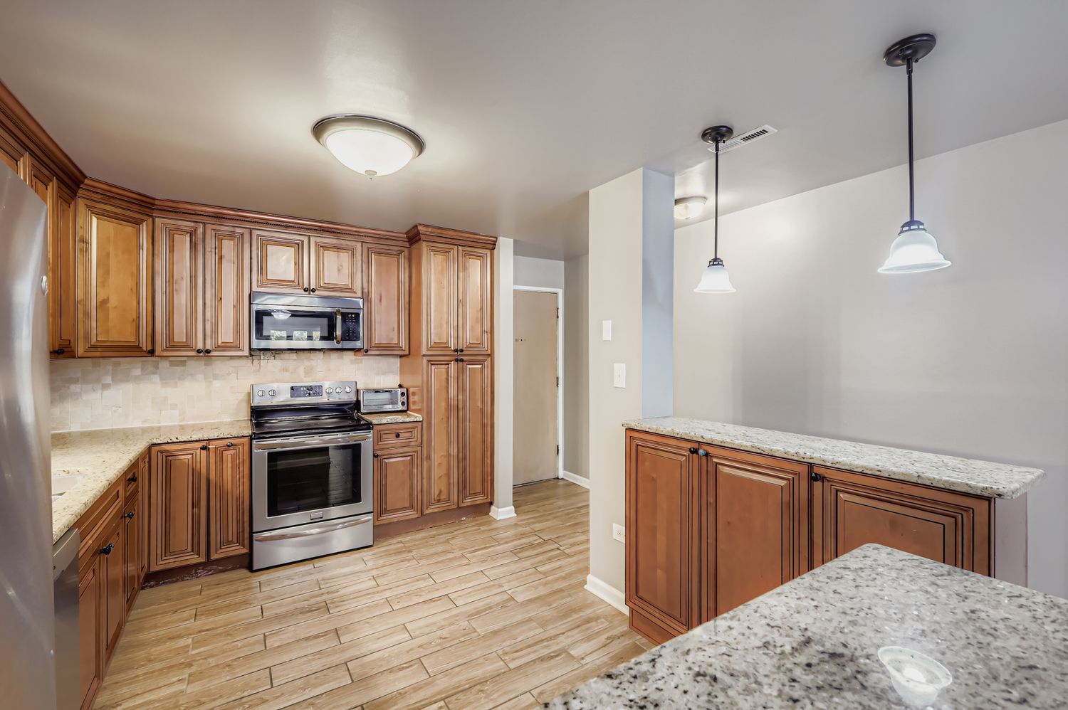 10048 South Pulaski Road, Unit 1E Oak Lawn, IL 60453 - Photo 6 of 27 a kitchen with stainless steel appliances granite countertop a refrigerator a stove top oven a sink dishwasher and wooden floor