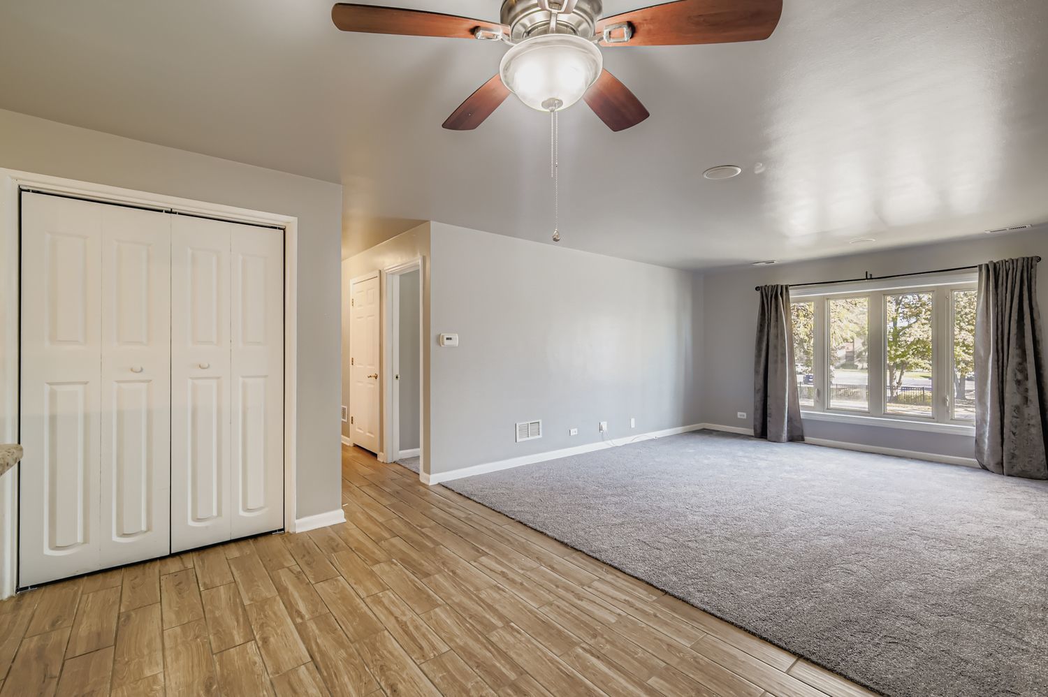 10048 South Pulaski Road, Unit 1E Oak Lawn, IL 60453 - Photo 8 of 27 a view of an empty room with a window and wooden floor