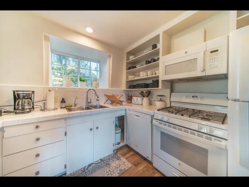 70 Eucalyptus Lane Santa Barbara, CA 93108 - Photo 13 of 47 a kitchen with cabinets appliances and a window