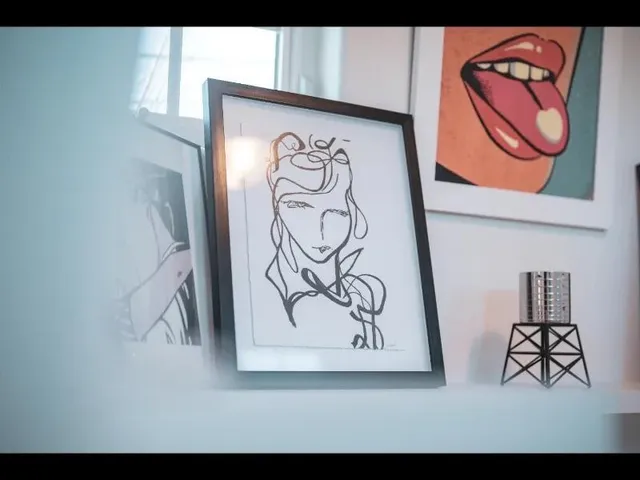 a living room with furniture and paintings on the wall