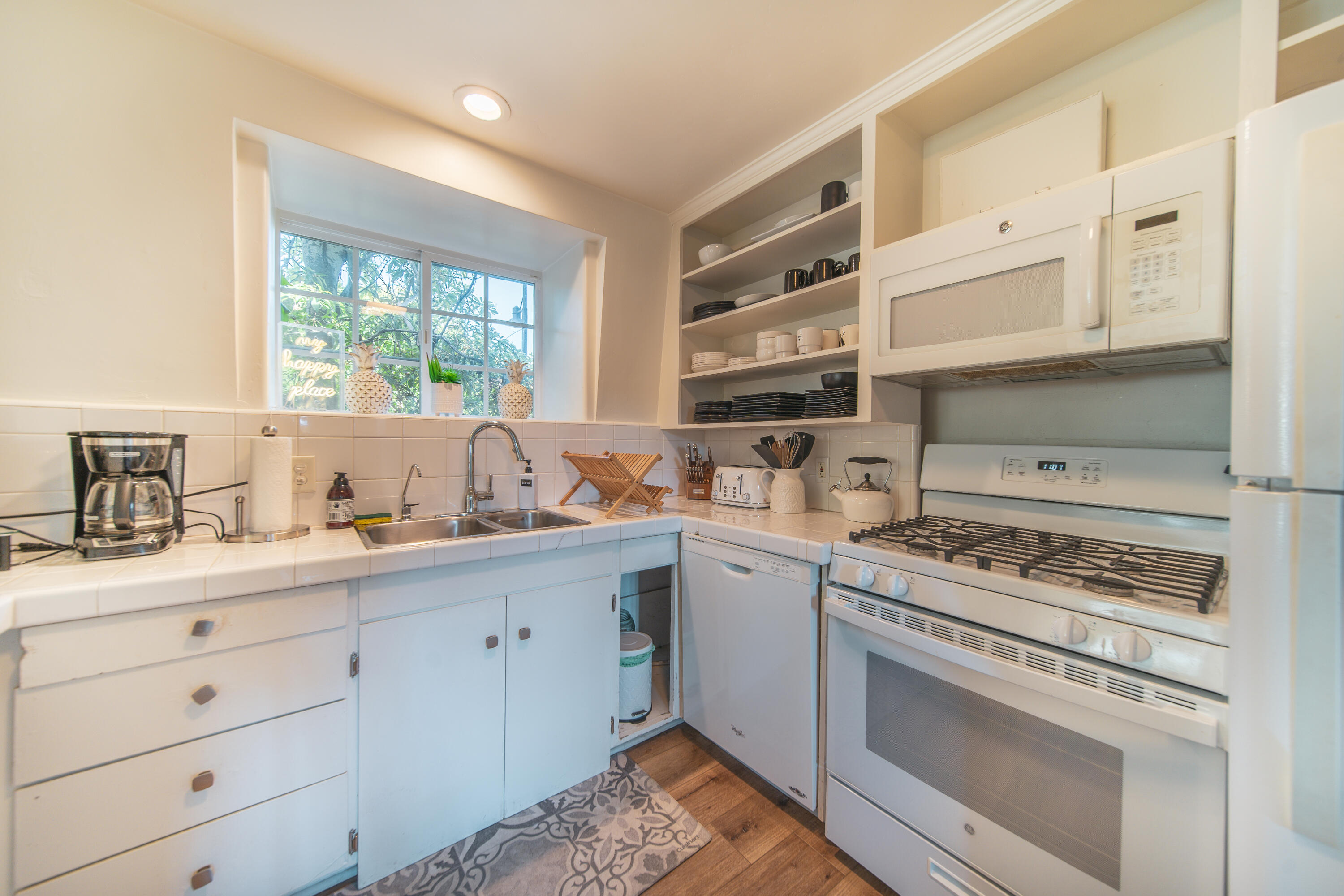 70 Eucalyptus Lane Santa Barbara, CA 93108 - Photo 4 of 47 a kitchen with cabinets appliances and a window