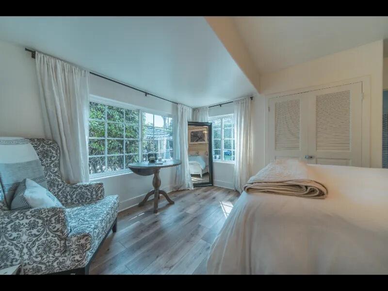 70 Eucalyptus Lane Santa Barbara, CA 93108 - Photo 7 of 47 a bedroom with a bed and wooden floor