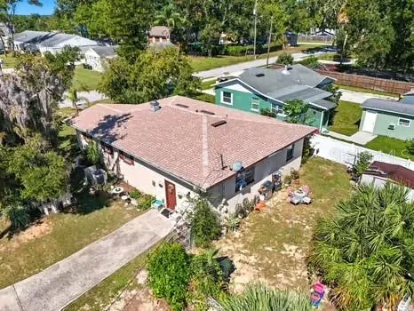an aerial view of a house with yard swimming pool and outdoor seating