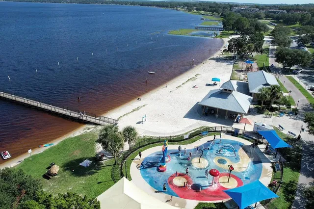 a bathroom with a toilet sink vanity and mirror