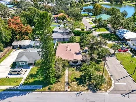 an aerial view of a house with a yard basket ball court and outdoor seating