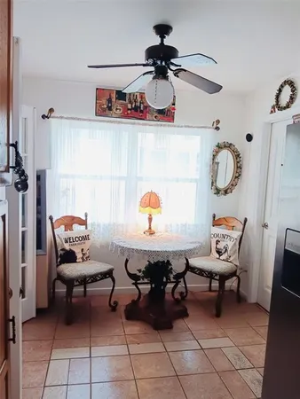 a living room with a mirror and a table