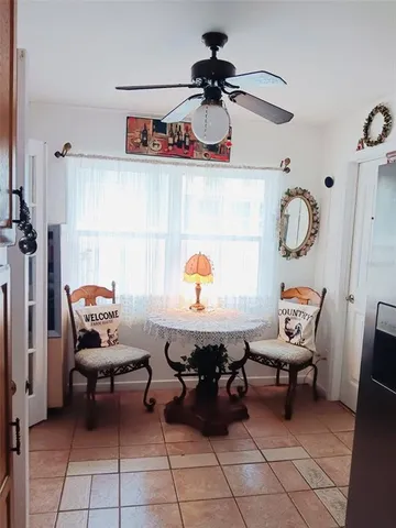 a living room with a mirror and a table