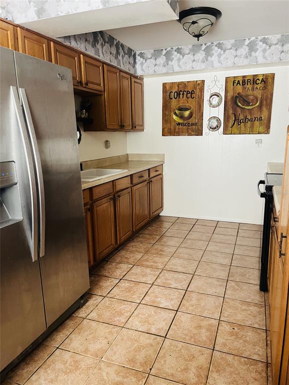 883 10th Street Clermont, FL 34711 - Photo 25 of 42 a kitchen with stainless steel appliances granite countertop a refrigerator and a stove top oven